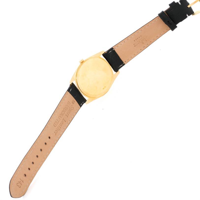 This image shows the back and strap of a Rolex Cellini 4233 Men's Yellow Gold Black Dial 4233 Men's Yellow Gold Black Dial watch from a top-down angle.