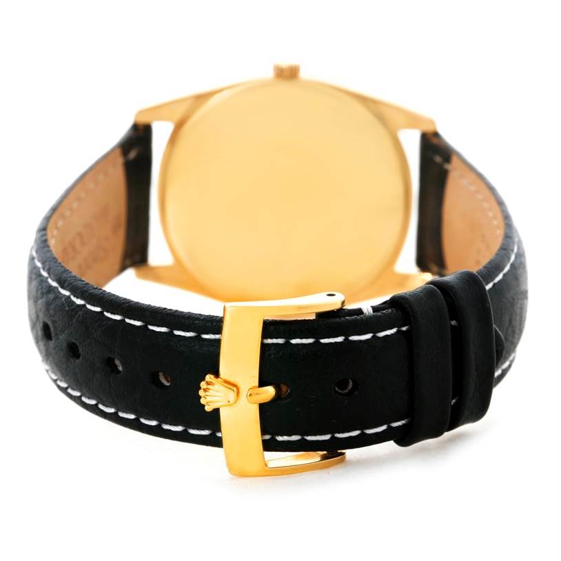 The image shows the rear view of a Rolex Cellini 4233 Men's Yellow Gold Black Dial 4233 Men's Yellow Gold Black Dial watch, highlighting its black leather strap and gold-tone buckle.