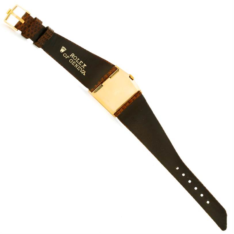 The image shows the Rolex Cellini 4126 Men's Yellow Gold Champagne Dial 4126 Men's Yellow Gold Champagne Dial watch from the back, highlighting its leather strap and gold buckle.