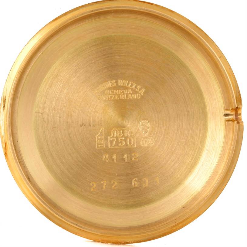 The image shows the inside of the case back for a Rolex Cellini 4112 Yellow Gold Champagne Dial 4112 Yellow Gold Champagne Dial model, featuring gold hallmarks and serial numbers.