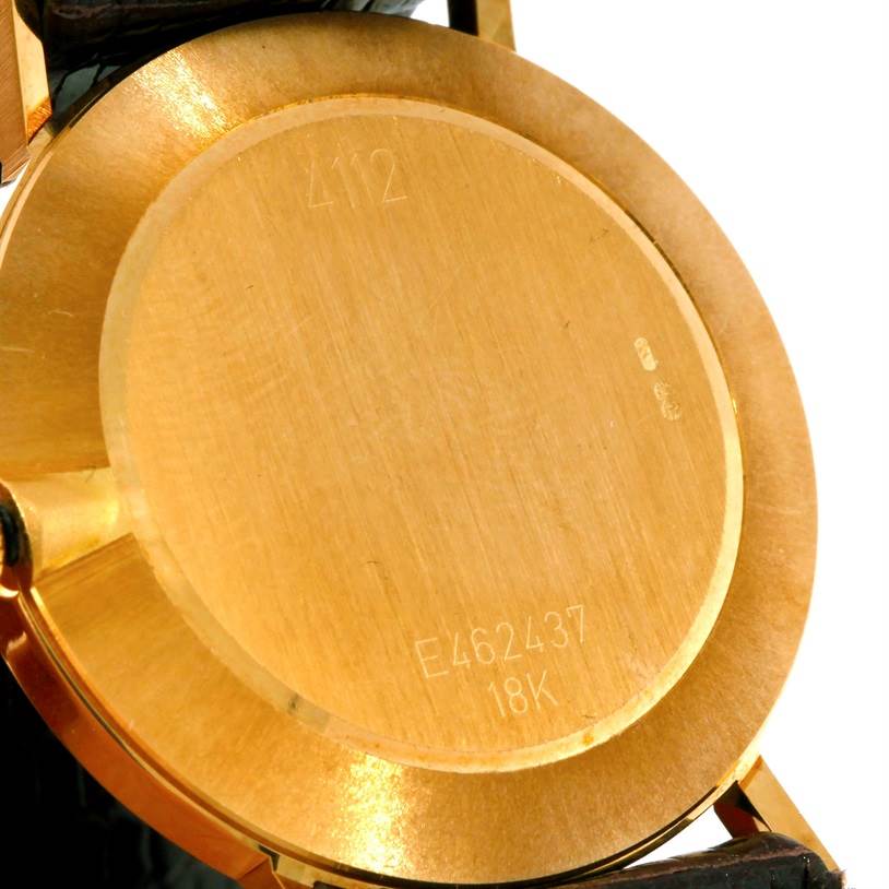 The image shows the back case of a Rolex Cellini 4112 Yellow Gold Champagne Dial 4112 Yellow Gold Champagne Dial watch, highlighting the case number and 18K gold engraving.