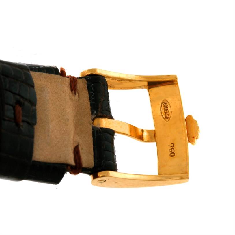 The image shows the gold buckle and part of the leather strap of a Rolex Cellini 4112 Yellow Gold Champagne Dial 4112 Yellow Gold Champagne Dial watch.