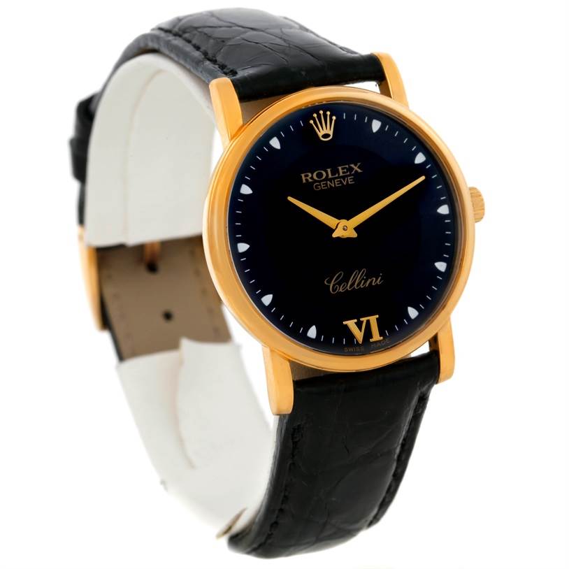 The image shows a Rolex Cellini 5115 Men
s Yellow Gold Black Dial 5115 Men
s Yellow Gold Black Dial watch angled from the front-left, highlighting its black leather strap, gold case, and dark dial.