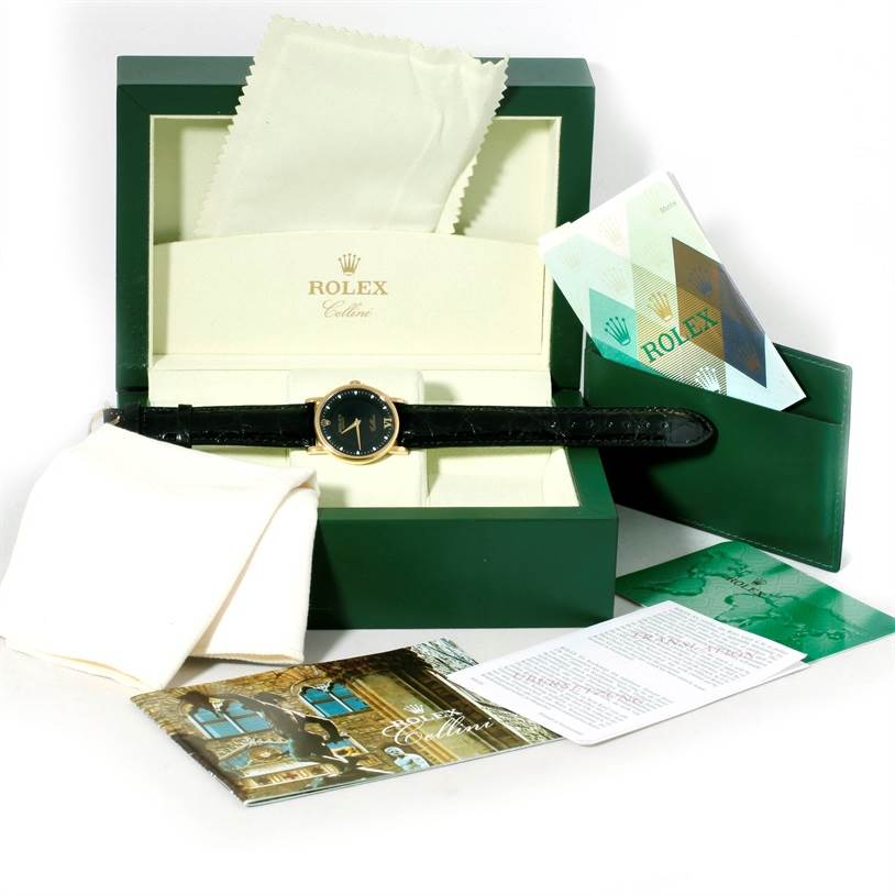 The Rolex Cellini 5115 Men
s Yellow Gold Black Dial 5115 Men
s Yellow Gold Black Dial watch is displayed in its box, accompanied by booklets, a cleaning cloth, and warranty card.