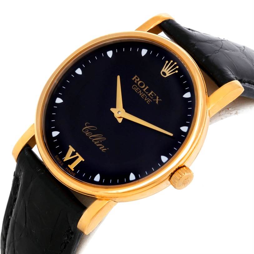 The image shows a close-up angle of the Rolex Cellini 5115 Men
s Yellow Gold Black Dial 5115 Men
s Yellow Gold Black Dial watch, featuring its black dial, gold hour markers, and black leather strap.