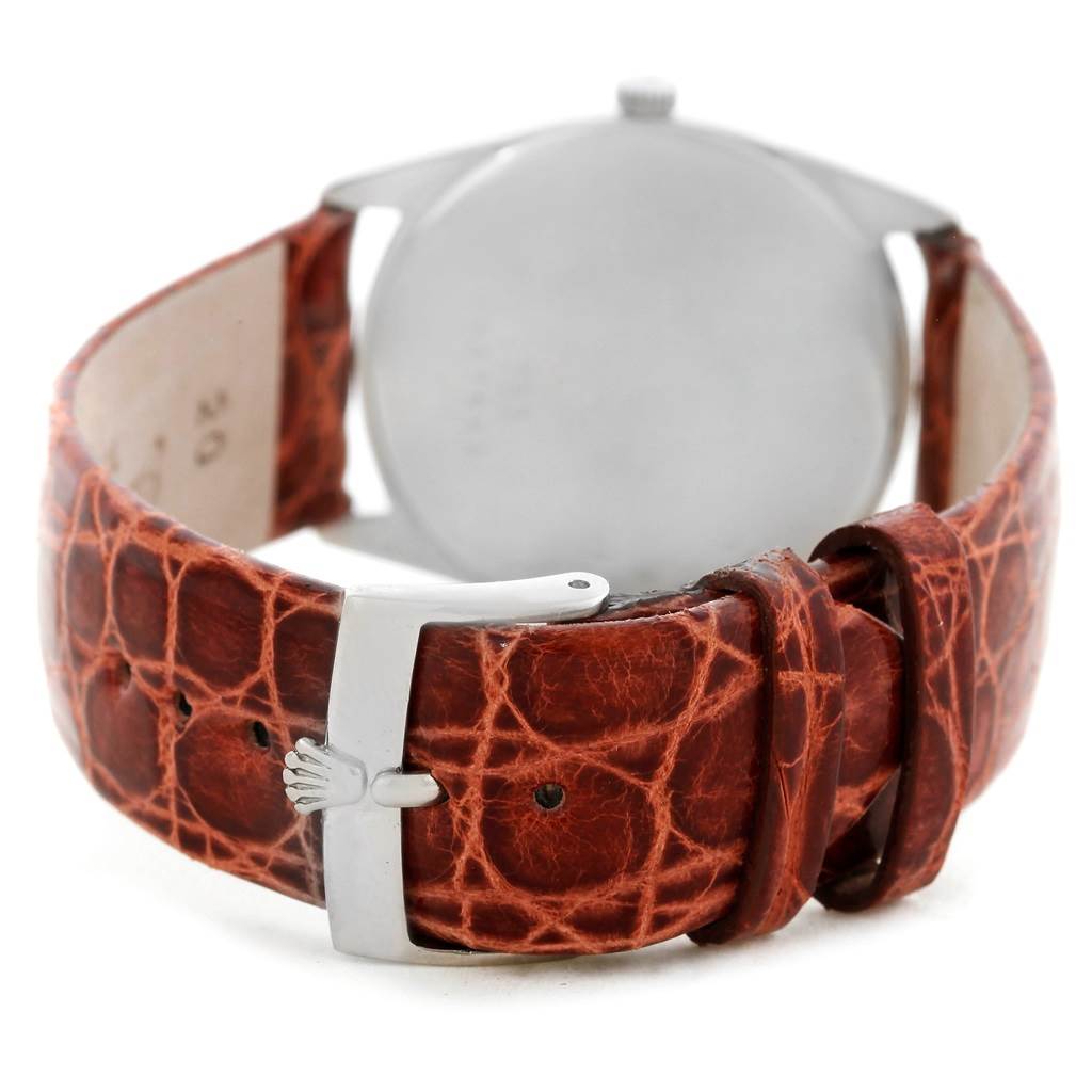 The image shows the back view of a Rolex Cellini 4233 Men's White Gold Black Dial 4233 Men's White Gold Black Dial watch featuring a brown leather strap and silver buckle.