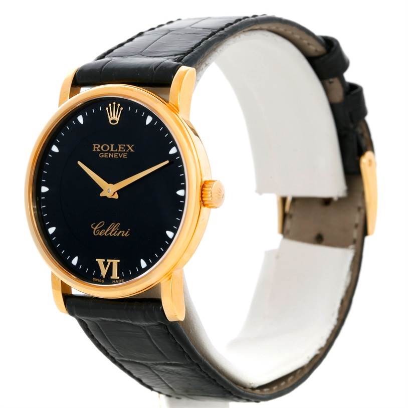 The Rolex Cellini 5115 Men's Yellow Gold Black Dial 5115 Men's Yellow Gold Black Dial watch is shown at an angle, displaying its black dial, gold case, and black leather strap.