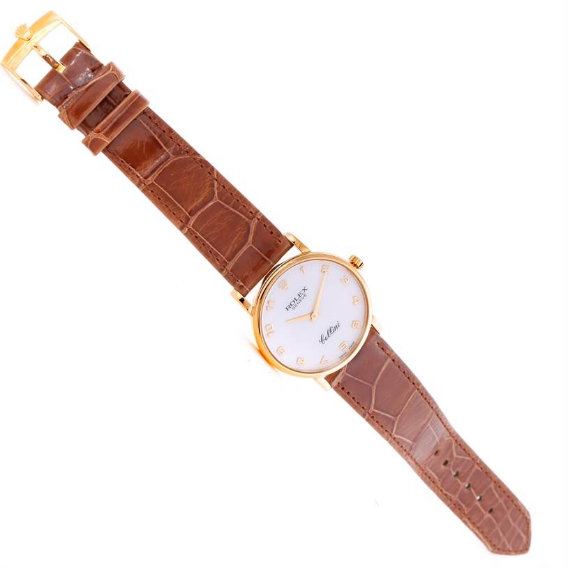 The Rolex Cellini 5115 Men
s Yellow Gold Mother of Pearl Dial 5115 Men
s Yellow Gold Mother of Pearl Dial watch is shown from a top-down angle, displaying the entire face, case, and brown leather strap.