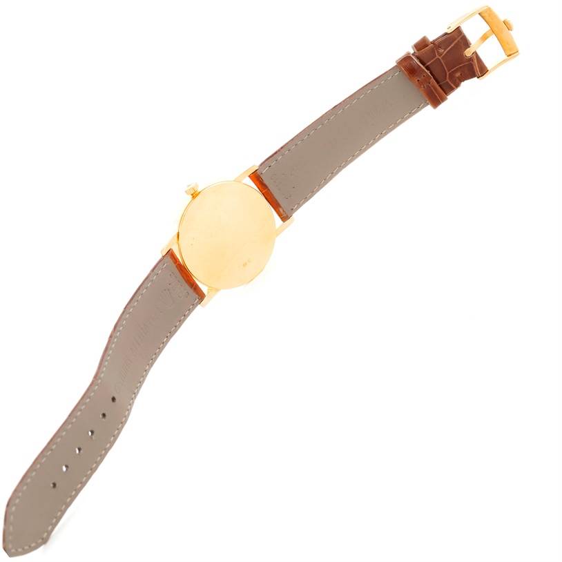 This image shows the back and strap of a Rolex Cellini 5115 Men
s Yellow Gold Mother of Pearl Dial 5115 Men
s Yellow Gold Mother of Pearl Dial watch from a top-down angle.