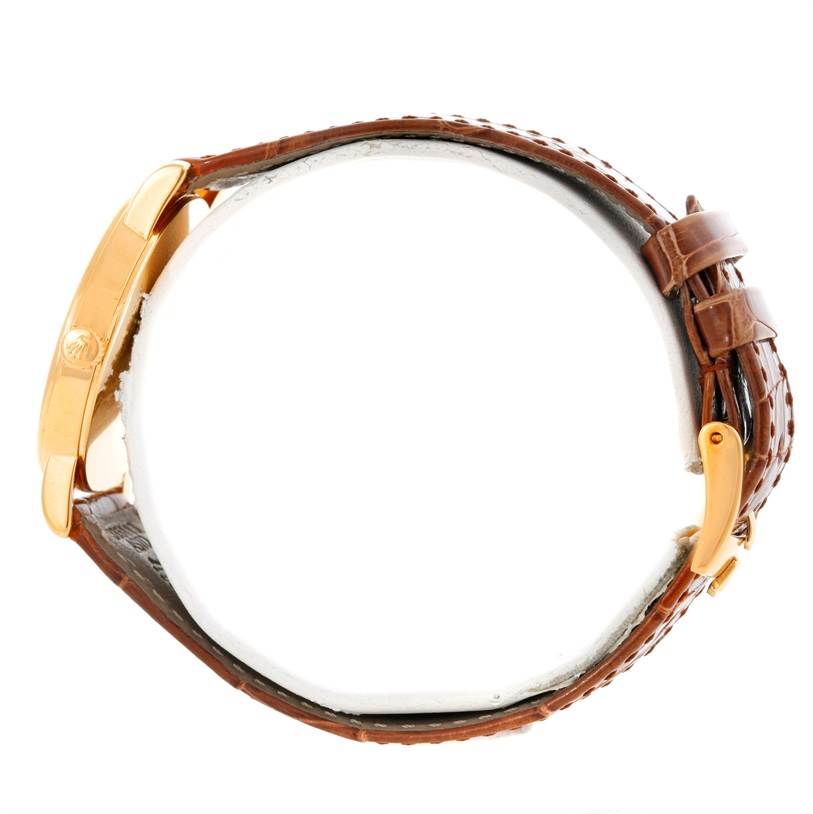 This image shows a Rolex Cellini 5115 Men
s Yellow Gold Mother of Pearl Dial 5115 Men
s Yellow Gold Mother of Pearl Dial watch from a side angle, highlighting the gold clasp and brown leather strap.