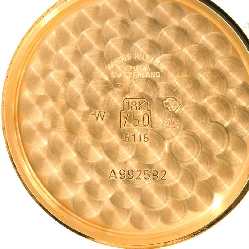 The image shows the inside of the case back of a Rolex Cellini 5115 Men
s Yellow Gold Mother of Pearl Dial 5115 Men
s Yellow Gold Mother of Pearl Dial watch, indicating it
s made of 18K gold.