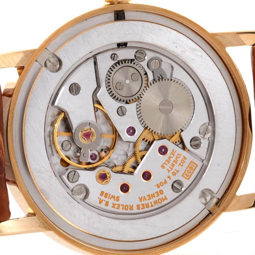 The image shows the exposed case back and intricate internal mechanism of a Rolex Cellini 5115 Men
s Yellow Gold Mother of Pearl Dial 5115 Men
s Yellow Gold Mother of Pearl Dial model watch.