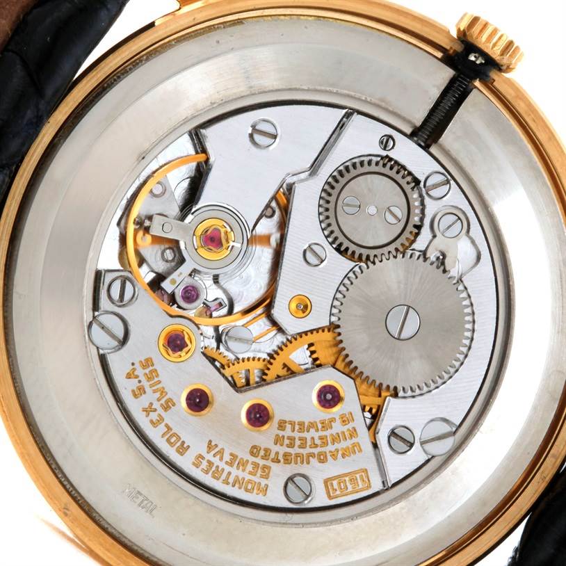 The image shows the rear view of a Rolex Cellini 5112 Men
s Yellow Gold Champagne Dial 5112 Men
s Yellow Gold Champagne Dial watch, displaying its intricate movement and internal components.