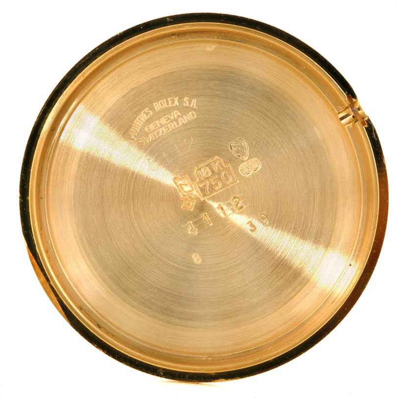 This image shows the inside of the case back of a Rolex Cellini 5112 Men
s Yellow Gold Champagne Dial 5112 Men
s Yellow Gold Champagne Dial watch, highlighting the engravings and markings.