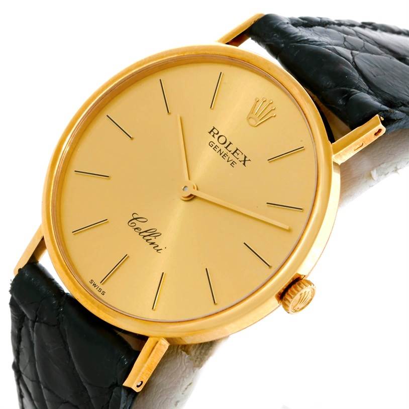 The Rolex Cellini 5112 Men
s Yellow Gold Champagne Dial 5112 Men
s Yellow Gold Champagne Dial watch is shown at a slight angle, featuring its gold face, black leather strap, and crown.