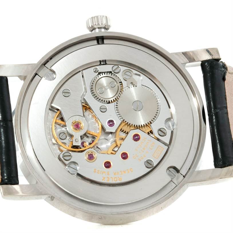 The image shows the back view of a Rolex Cellini 5115 Men
s White Gold Silver Dial 5115 Men
s White Gold Silver Dial model watch, revealing its intricate mechanical movement.