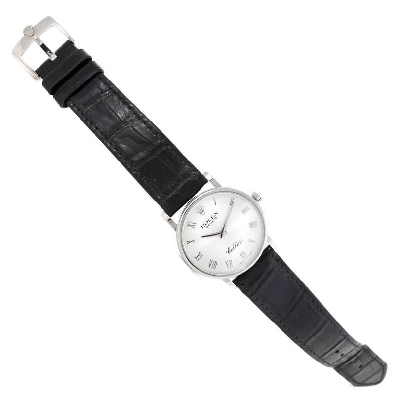 The Rolex Cellini 5115 Men
s White Gold Silver Dial 5115 Men
s White Gold Silver Dial watch is shown at a slight angle displaying its face, black leather strap, and clasp.