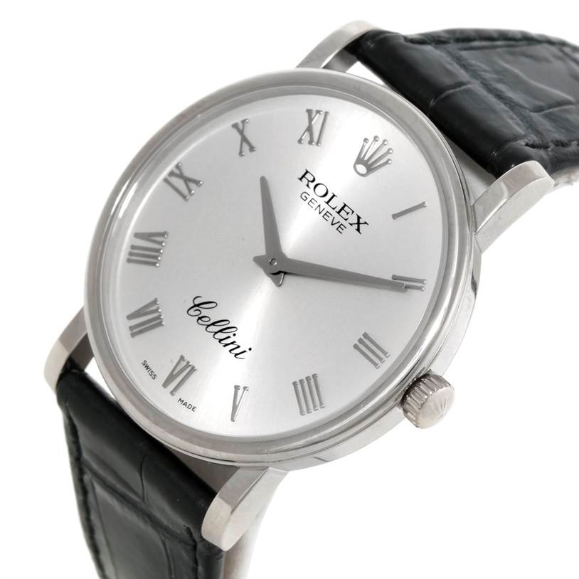 The Rolex Cellini 5115 Men
s White Gold Silver Dial 5115 Men
s White Gold Silver Dial watch is shown from an angled front view, displaying the dial, Roman numerals, case, crown, and leather strap.