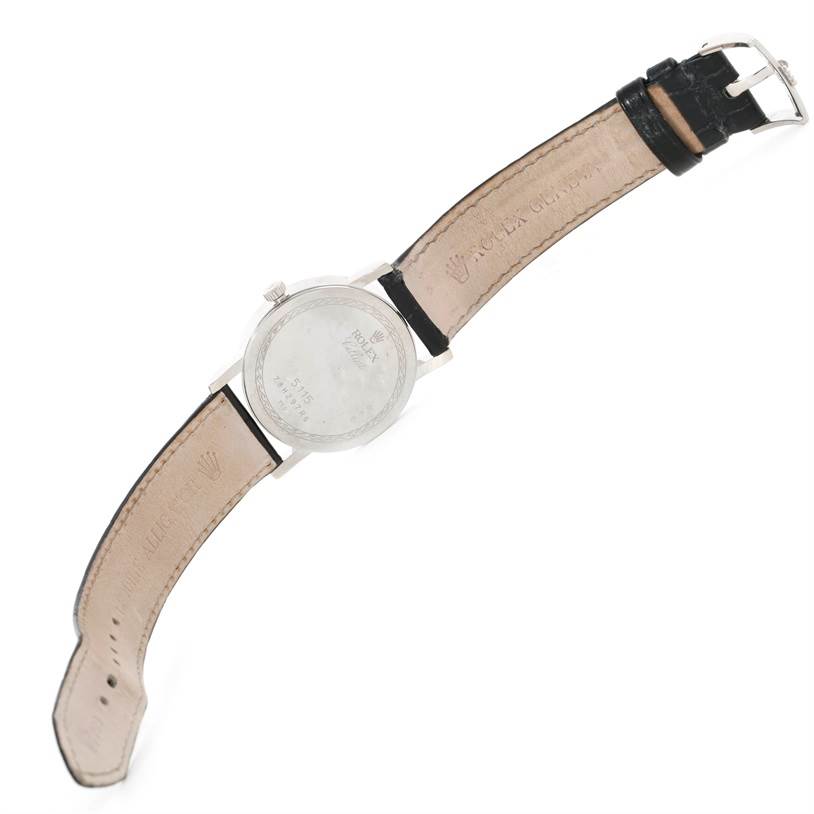 This image shows a Rolex Cellini 5115 Men
s White Gold Silver Dial 5115 Men
s White Gold Silver Dial watch from a top-down view, focusing on the back case and leather straps.