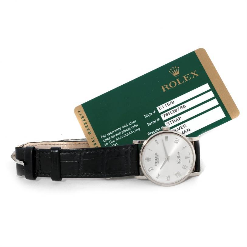 The Rolex Cellini 5115 Men
s White Gold Silver Dial 5115 Men
s White Gold Silver Dial watch is shown from the front angle alongside its warranty card, highlighting its face and strap.