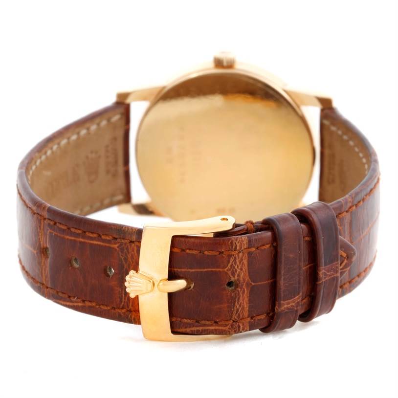 The image shows the back view of a Rolex Cellini 5116 Men's Yellow Gold Grey Dial 5116 Men's Yellow Gold Grey Dial watch, highlighting the leather strap and gold buckle.