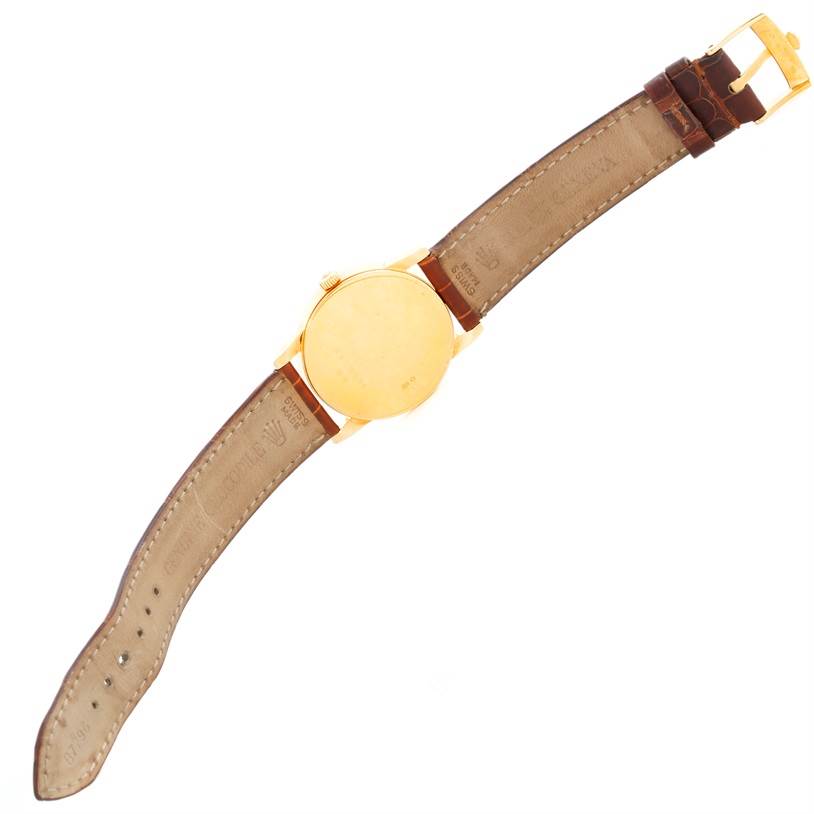 The image shows the back and leather strap of a Rolex Cellini 5116 Men's Yellow Gold Grey Dial 5116 Men's Yellow Gold Grey Dial watch from a top view angle.