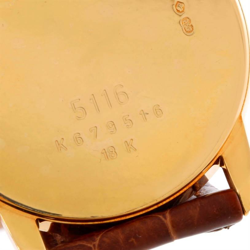 This photo shows the back case of a Rolex Cellini 5116 Men's Yellow Gold Grey Dial 5116 Men's Yellow Gold Grey Dial model watch, highlighting the engraved serial numbers and the leather strap attachment.