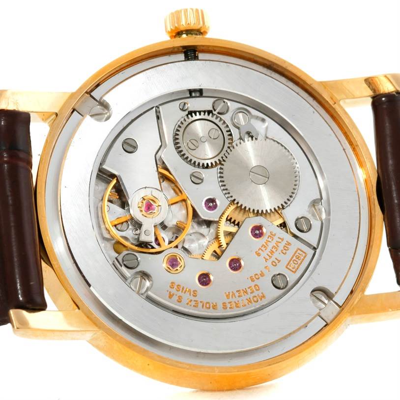 The image shows the internal mechanical movements of a Rolex Cellini 5115 Men
s Yellow Gold Silver Dial 5115 Men
s Yellow Gold Silver Dial watch with visible gears and jewels.