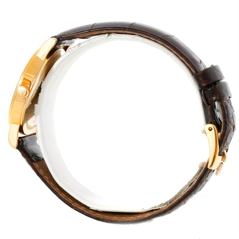 The image shows a side view of the Rolex Cellini 5115 Men
s Yellow Gold Silver Dial 5115 Men
s Yellow Gold Silver Dial watch, highlighting its gold case and brown leather strap.