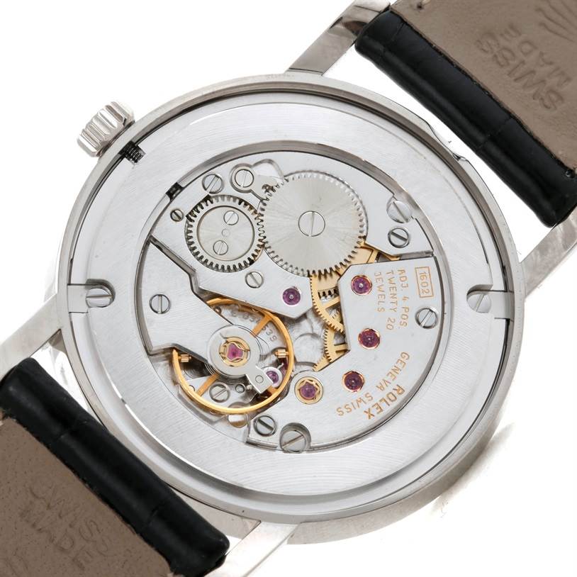 The image shows the back view of a Rolex Cellini 5115 Men's White Gold Silver Dial 5115 Men's White Gold Silver Dial watch, highlighting its intricate mechanical movement and internal gears.