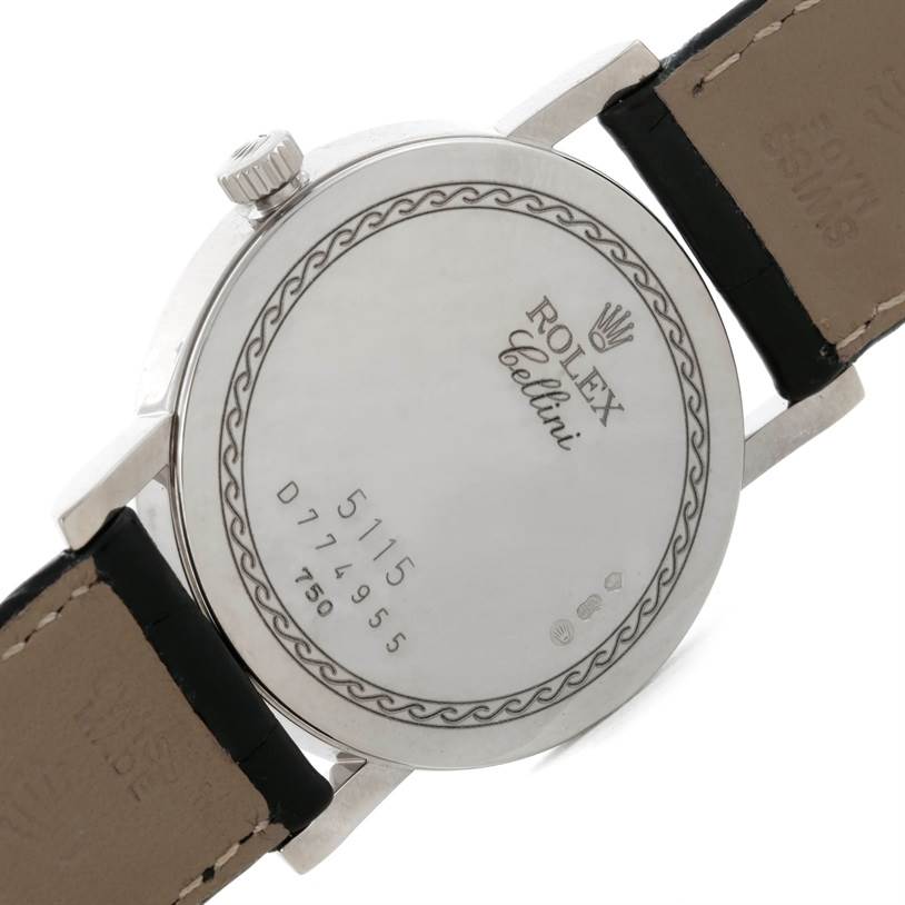 The image shows the back of a Rolex Cellini 5115 Men's White Gold Silver Dial 5115 Men's White Gold Silver Dial watch case and part of the leather strap.