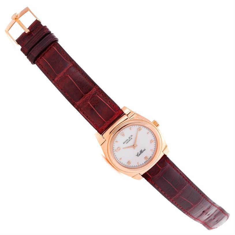 The Rolex Cellini 5320 Rose Gold White Dial 5320 Rose Gold White Dial watch is shown from a top-down angle, displaying the face, leather strap, and buckle.