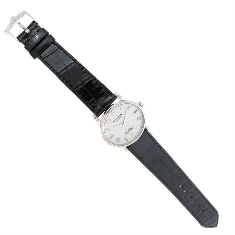 The Rolex Cellini 5116 Men's White Gold Silver Dial 5116 Men's White Gold Silver Dial watch is shown fully extended from a slightly elevated angle, displaying its black leather strap and silver dial.