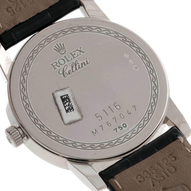 The image shows the back case of a Rolex Cellini 5116 Men's White Gold Silver Dial 5116 Men's White Gold Silver Dial model, displaying the brand name, serial numbers, and part of the leather strap.