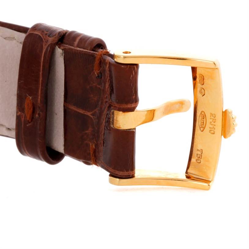 This image shows a close-up of the gold clasp and brown leather strap of a Rolex Cellini 5115 Men
s Yellow Gold Silver Dial 5115 Men
s Yellow Gold Silver Dial watch.