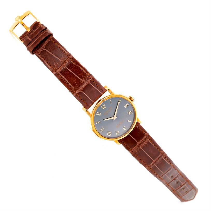The image shows a Rolex Cellini 5115 Men's Yellow Gold Grey Dial 5115 Men's Yellow Gold Grey Dial watch laid flat, with a brown leather strap and gold case, viewed from a top-down angle.