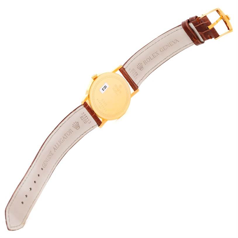 The image shows the underside of the Rolex Cellini 5115 Men's Yellow Gold Grey Dial 5115 Men's Yellow Gold Grey Dial watch, displaying its back case and leather strap.