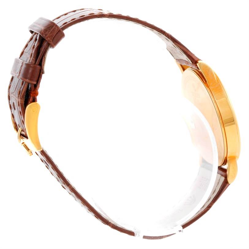 The image shows a side view of a Rolex Cellini 5115 Men's Yellow Gold Grey Dial 5115 Men's Yellow Gold Grey Dial watch, highlighting its brown leather strap and gold case.