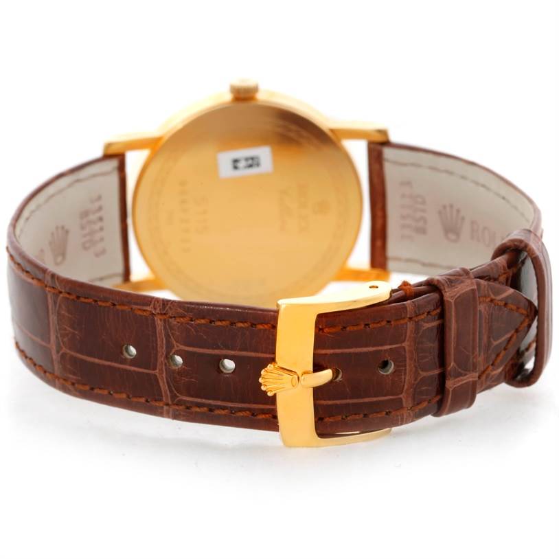 The image shows the back view of a Rolex Cellini 5115 Men's Yellow Gold Grey Dial 5115 Men's Yellow Gold Grey Dial watch with a focus on the leather strap and gold buckle.