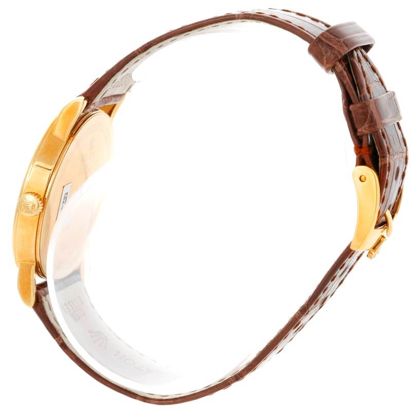 Side view of a Rolex Cellini 5115 Men's Yellow Gold Grey Dial 5115 Men's Yellow Gold Grey Dial watch, showcasing its gold case, crown, and brown leather strap with a gold buckle.