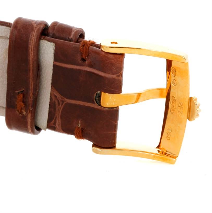 This image shows a close-up view of the Rolex Cellini 5115 Men's Yellow Gold Grey Dial 5115 Men's Yellow Gold Grey Dial's brown leather strap and gold buckle.