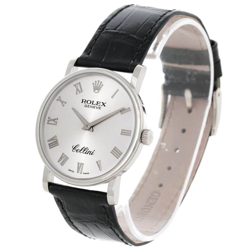 The image shows a Rolex Cellini 5115 Men
s White Gold Silver Dial 5115 Men
s White Gold Silver Dial watch at a slight front angle, displaying the face, Roman numeral markers, and black leather strap.
