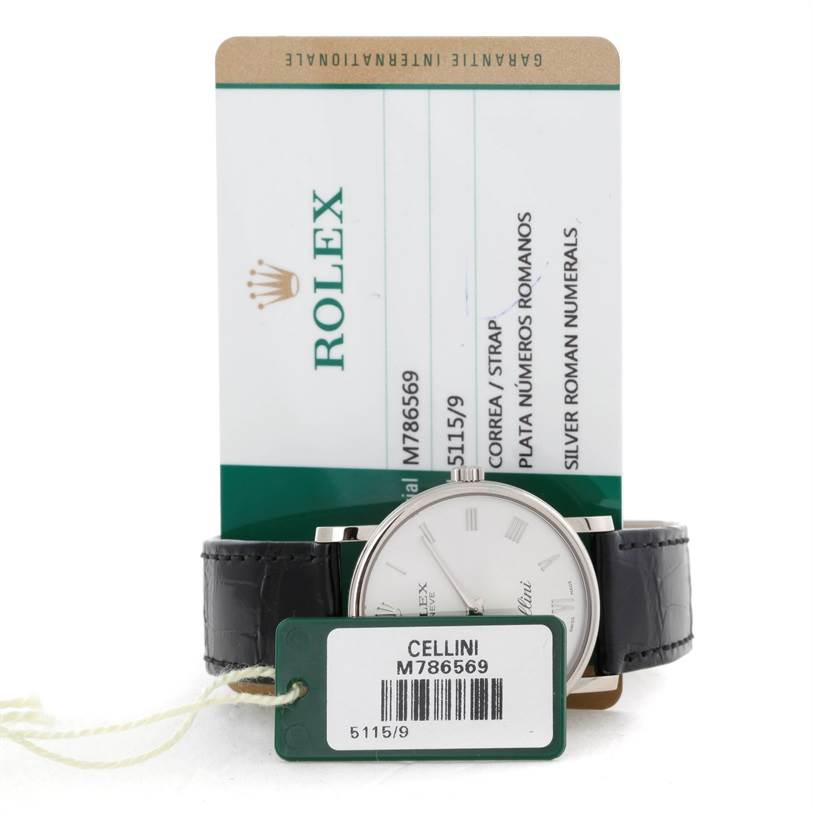The Rolex Cellini 5115 Men
s White Gold Silver Dial 5115 Men
s White Gold Silver Dial watch is shown with its face, leather strap, and an attached model tag, along with its information card.