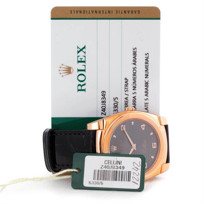 This image shows a Rolex Cellini 5330 Men's Rose Gold Grey Dial 5330 Men's Rose Gold Grey Dial watch partially visible from the front, along with a registration card and a tag.
