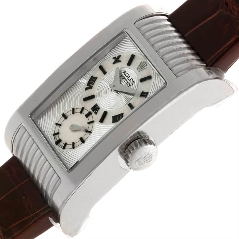 The Rolex Cellini 5441 Men's White Gold Silver Dial 5441 Men's White Gold Silver Dial watch is shown from a side angle, highlighting the crown, the rectangular dial with Roman numerals, and the leather strap.