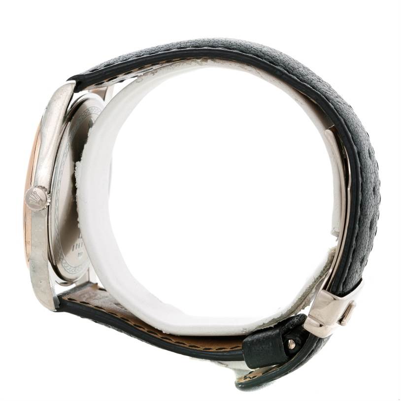 This side view of the Rolex Cellini Men's White Gold Black Dial Men's White Gold Black Dial watch shows the case, crown, black leather strap, and buckle.