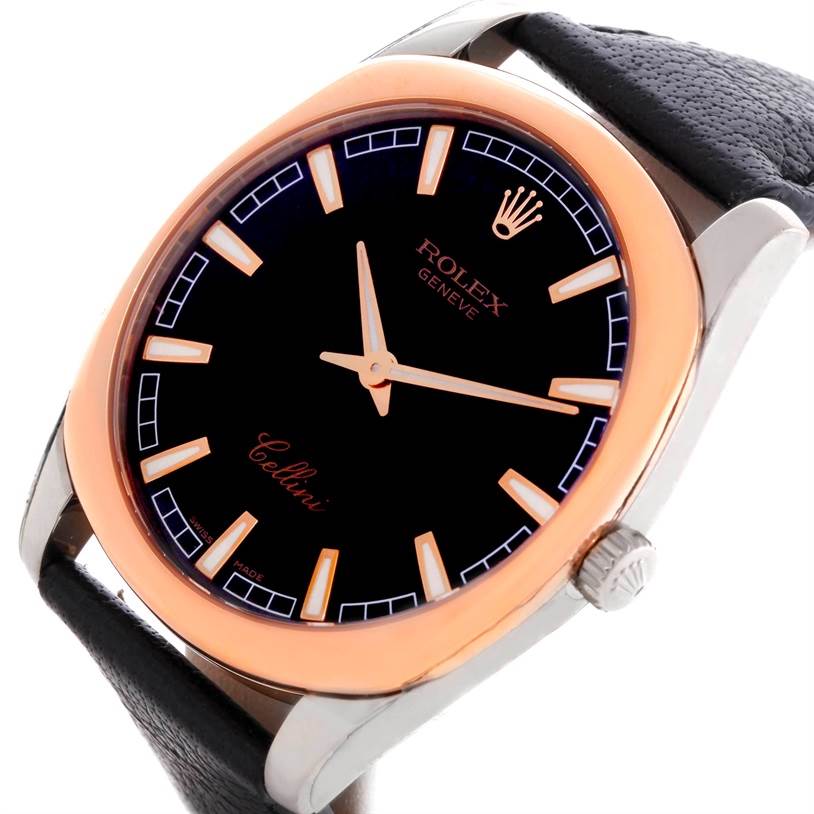 The Rolex Cellini Men's White Gold Black Dial Men's White Gold Black Dial watch is shown at a slight angle, displaying its black dial, gold hands, bezel, and leather strap.