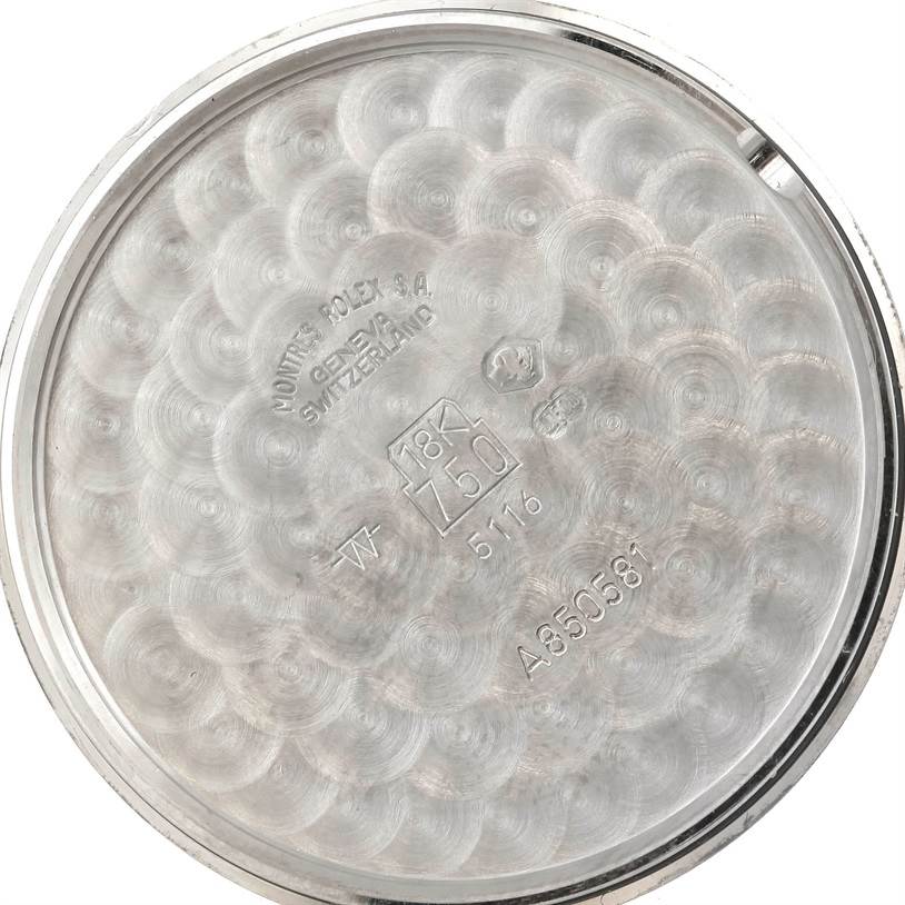 This image shows the inner part of the case back of a Rolex Cellini 5116 Men's White Gold Black Dial 5116 Men's White Gold Black Dial watch, displaying various engravings and stamps.