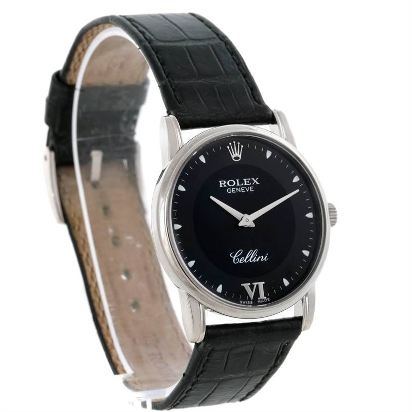The Rolex Cellini 5116 Men's White Gold Black Dial 5116 Men's White Gold Black Dial watch is shown at an angle highlighting its face, black dial, silver case, and black leather strap.