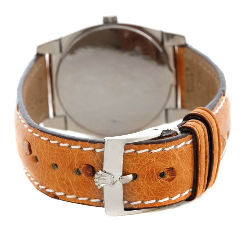 The image shows the back view of a Rolex Cellini 5320 Men's White Gold White Dial 5320 Men's White Gold White Dial watch focusing on its tan leather strap and silver clasp.